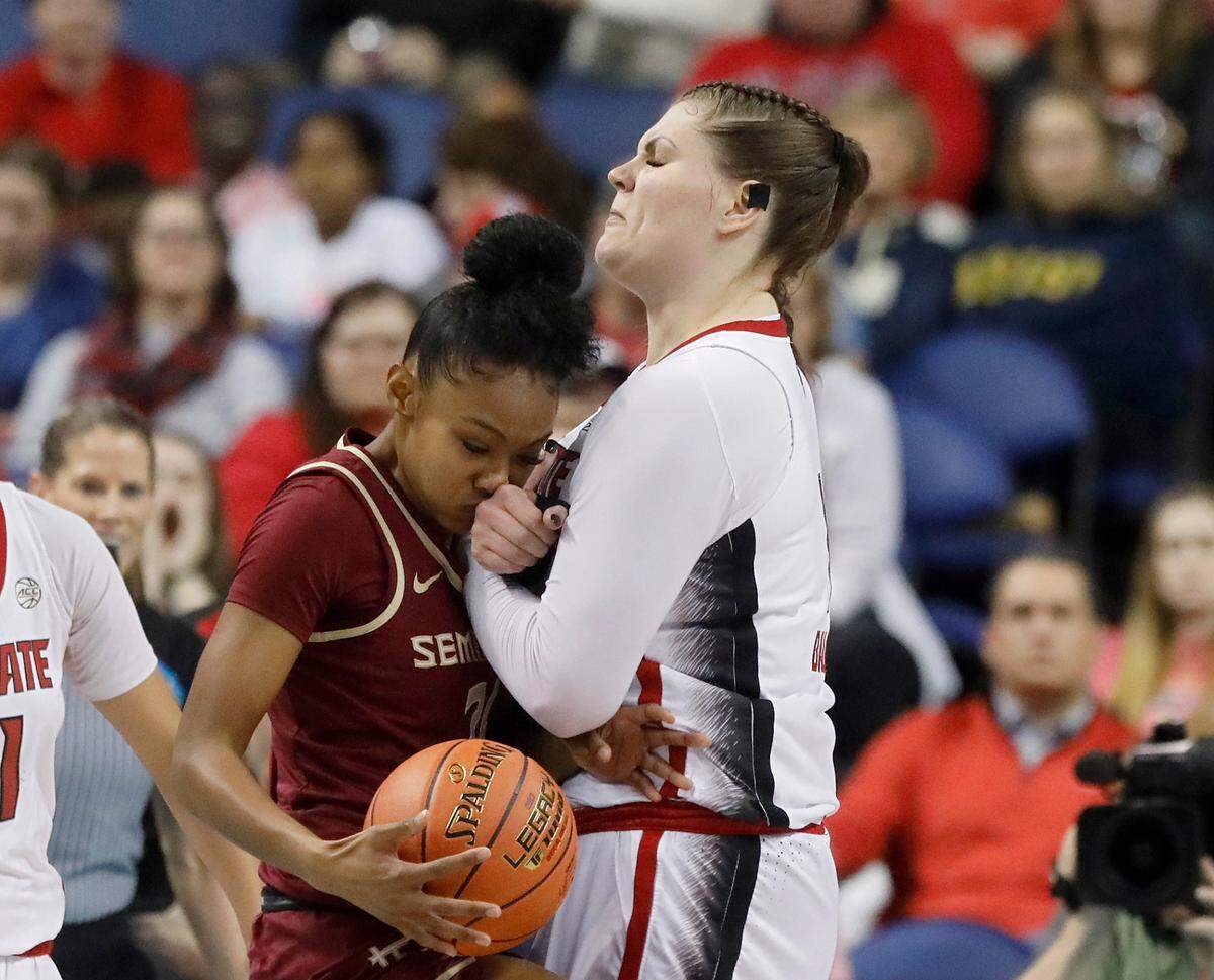 N.C. State’s River Baldwin takes a charge against Florida State’s Amaya Bonner during the first half of an ACC Tournament semifinal game on Saturday, March 9, 2024, at Greensboro Coliseum in Greensboro, N.C.