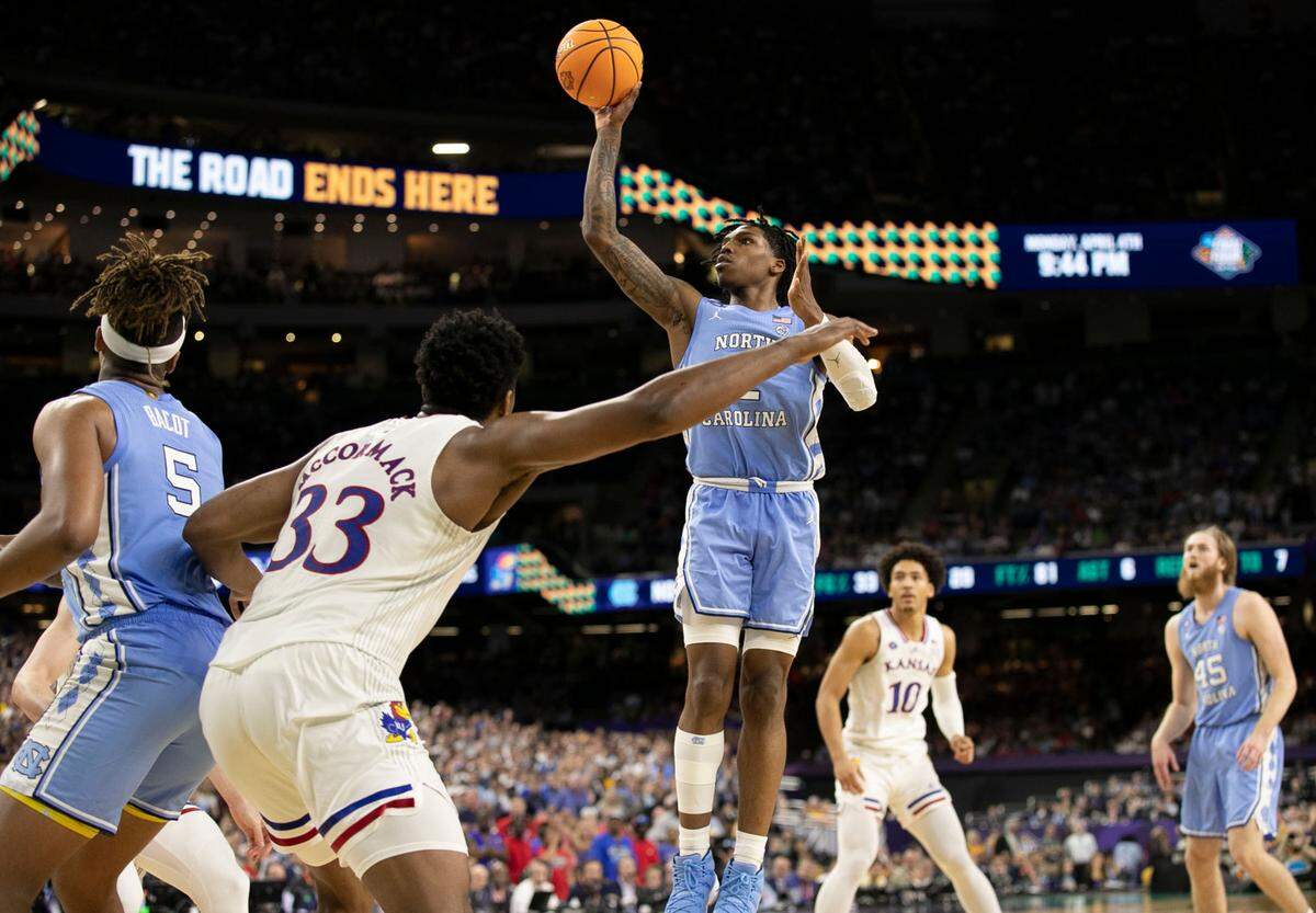 North Carolina’s Caleb Love (2) drives to the basket against Kansas’ David McCormack (33) in the second half during the NCAA Championship game on Monday, April 4, 2022 at Caesars Superdome in New Orleans, La.