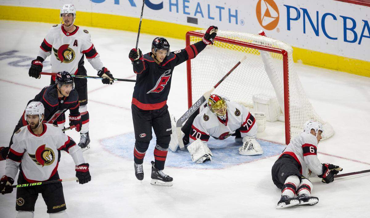 The Carolina Hurricanes Jesperi Kotkaniemi (82) reacts after a goal by teammate Teuvo Teravainen (86) to give the Hurricanes a 2-1 lead in the second period on Wednesday, October 11, 2023 at PNC Arena, in Raleigh N.C.