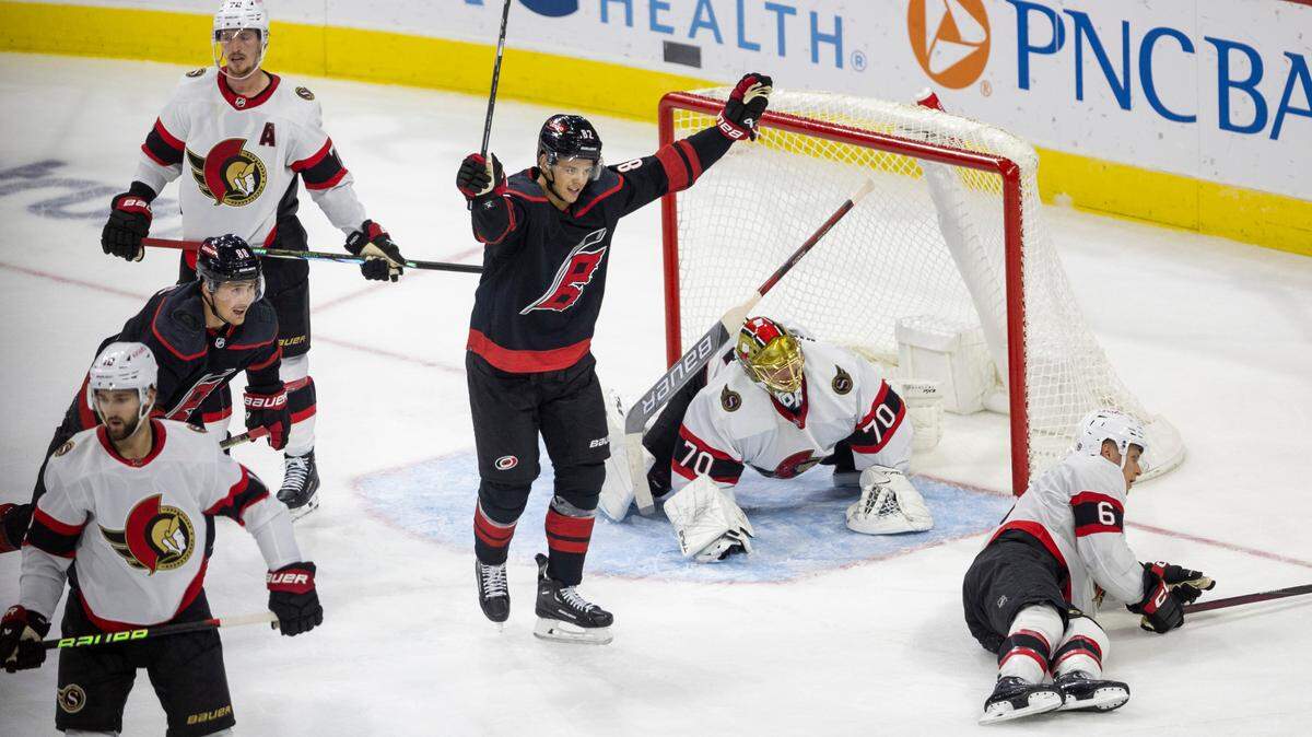 The Carolina Hurricanes Jesperi Kotkaniemi (82) reacts after a goal by teammate Teuvo Teravainen (86) to give the Hurricanes a 2-1 lead in the second period on Wednesday, October 11, 2023 at PNC Arena, in Raleigh N.C.