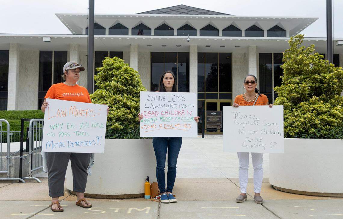 From left, Beth Putz, Maddie Segal and Sonia Vega protest outside the N.C. Legislative Building in Raleigh, N.C., Wednesday, May 25, 2022. Segal was moved to protest after the fatal shooting of elementary school students in Uvalde, Texas Tuesday. We are all at a loss for what to do so this one thing I know I can do said Segal, who wants lawmakers to pass common sense gun regulation.