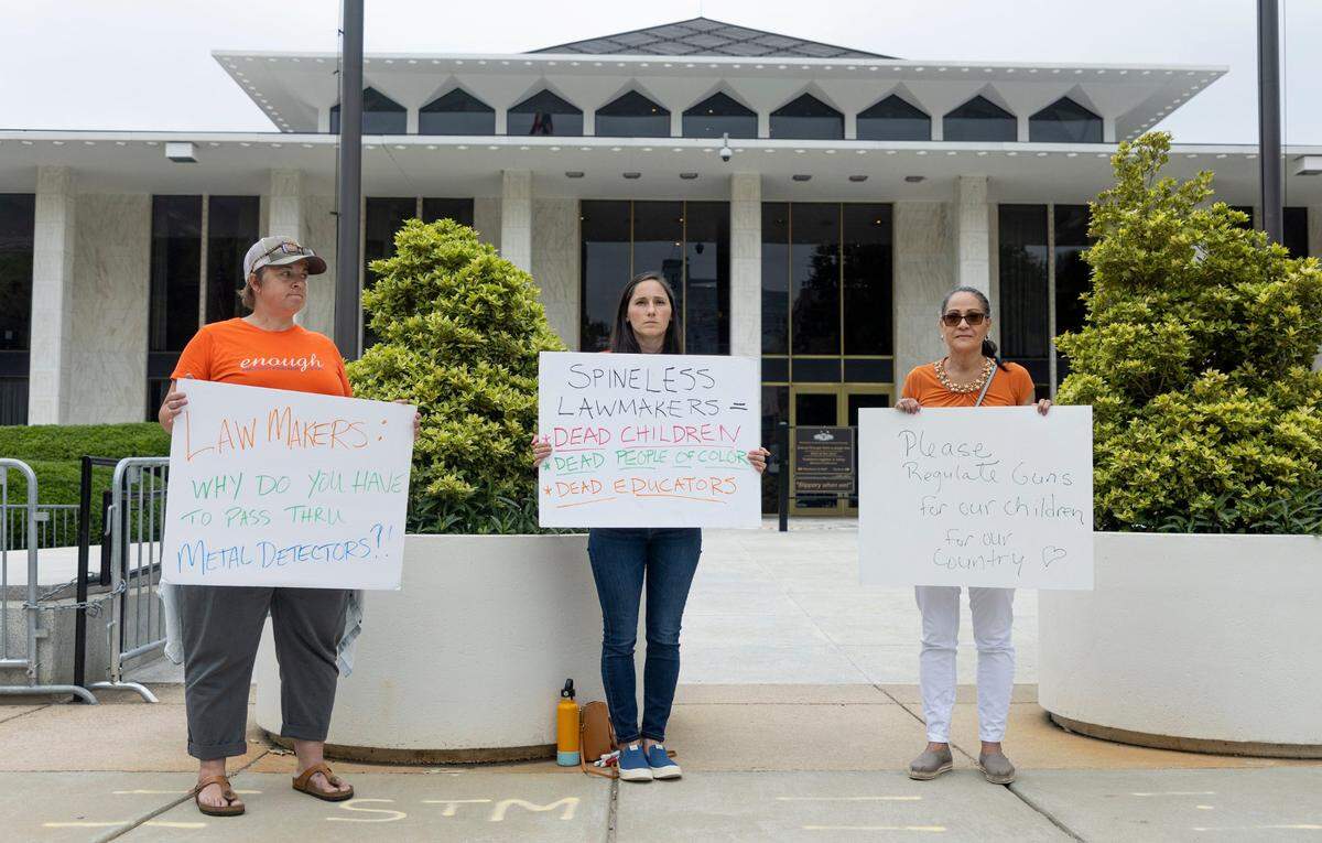 From left, Beth Putz, Maddie Segal and Sonia Vega protest outside the N.C. Legislative Building in Raleigh, N.C., Wednesday, May 25, 2022. Segal was moved to protest after the fatal shooting of elementary school students in Uvalde, Texas Tuesday. We are all at a loss for what to do so this one thing I know I can do said Segal, who wants lawmakers to pass common sense gun regulation.