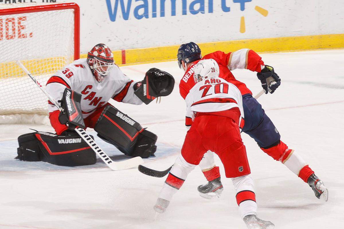 Carolina Hurricanes goaltender Alex Nedeljkovic (39) stops a shot by Florida Panthers center Sam Bennett (9) during the first period of an NHL hockey game Saturday, April 24, 2021, in Sunrise, Fla. (AP Photo/Joel Auerbach)