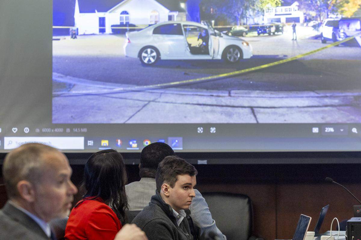 Austin Thompson, 18, listens to testimony as a photograph of the crime scene where officer Gabriel Torres was shot and killed is displayed on a screen during Thompson’s sentencing hearing in Wake County Superior Court in Raleigh on Tuesday, Feb. 3, 2026. Thompson previously pleaded guilty to murder in the 2022 Hedingham neighborhood mass shooting, the deadliest mass shooting in the city's history.