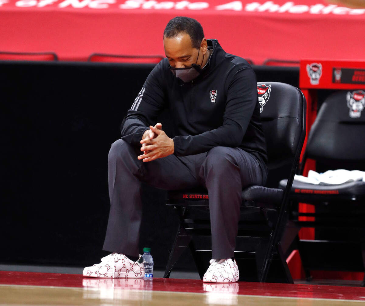 N.C. State head coach Kevin Keatts watches from his seat during the second half of Virginia’s 64-57 victory over N.C. State at PNC Arena in Raleigh, N.C., Wednesday, February 3, 2021.