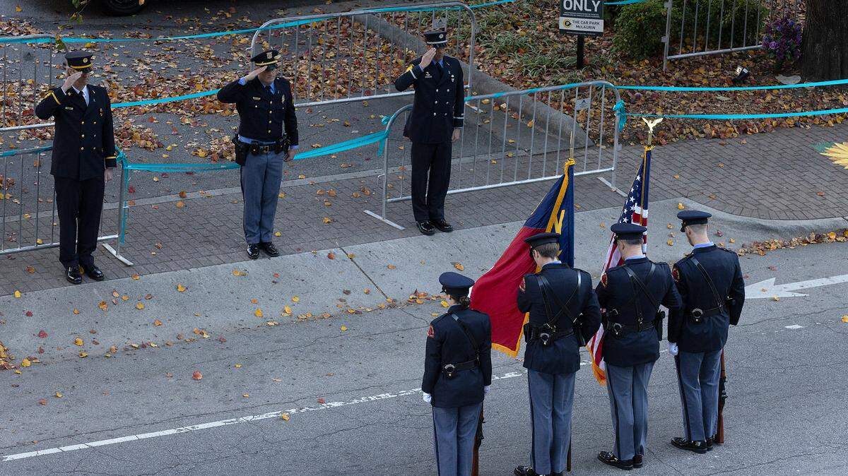 Law enforcement pause for a moment of silence to honor Hailey Brooks at the start of the Raleigh Christmas Parade on Saturday, Nov. 18, 2023. Brooks, an 11-year-old dancer, was struck by a truck during last year’s parade. She died of her injuries.