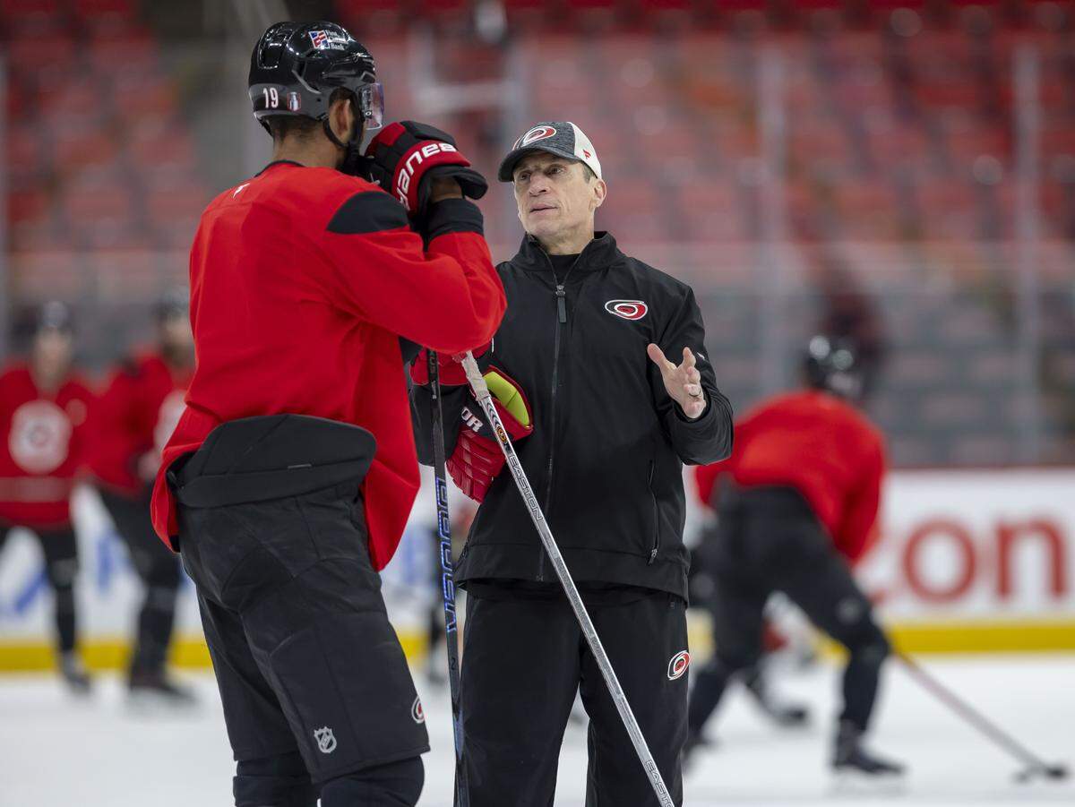 Carolina Hurricanes coach Rod Brind’Amour talks with defenseman K’Andre Miller (19) during practice on Friday, May 15, 2026 at Lenovo Center in Raleigh, N.C.