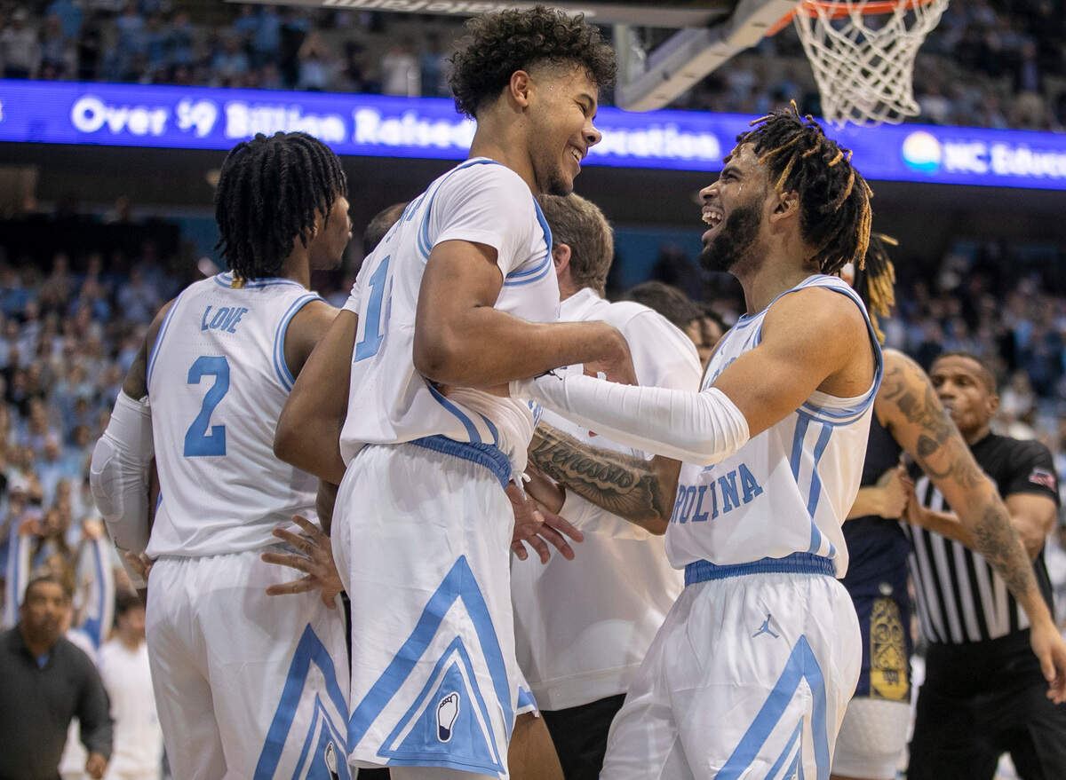 North Carolina’s R.J. Davis (4) congratulates Puff Johnson (14) after Johnson scored on a dunk and drew a foul in the second half against Notre Dame on Saturday, January 7, 2023 at the Smith Center in Chapel Hill, N.C.