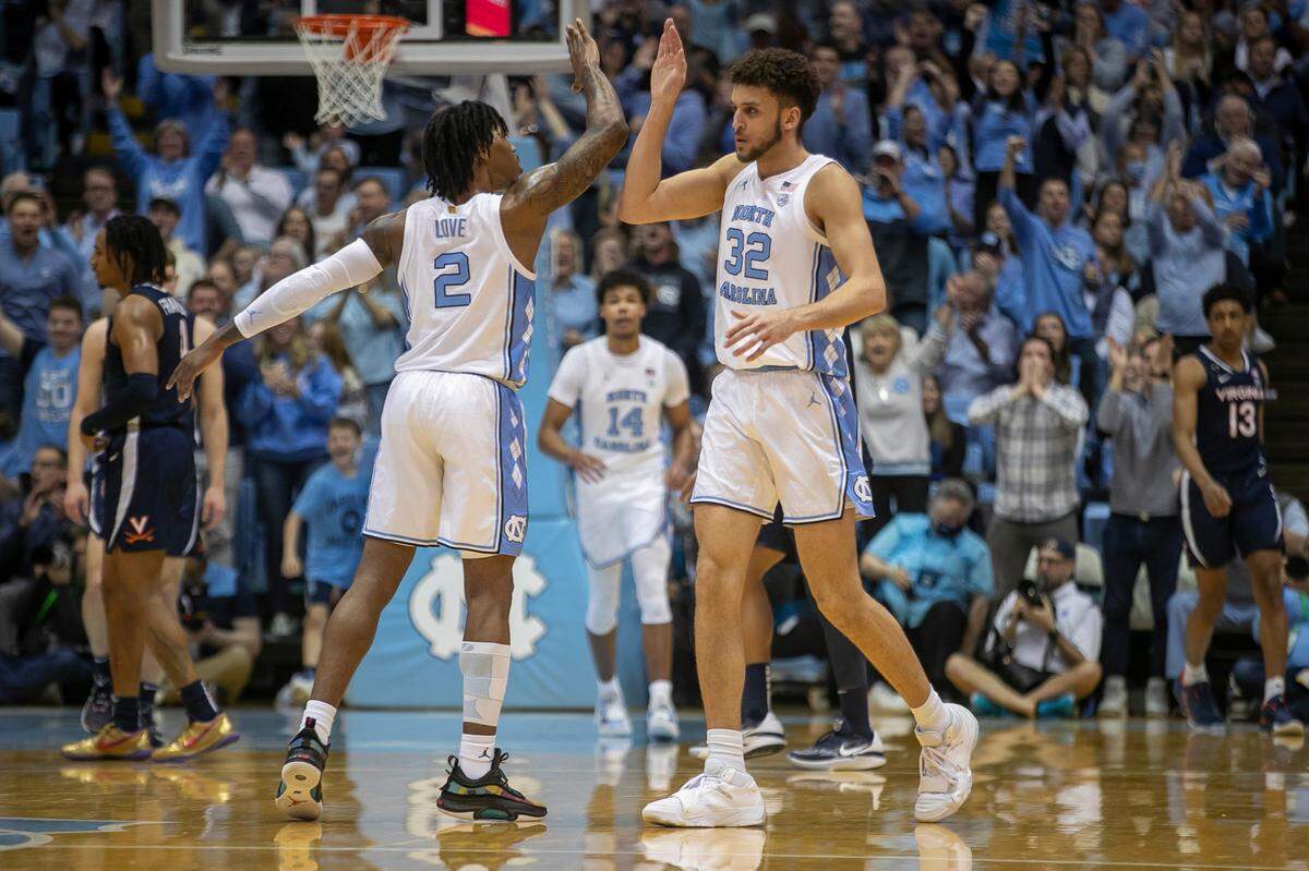 North Carolina’s Pete Nance (32) is congratulated by Caleb Love (2) after sinking a three point basket against Virginia during the first half on Saturday, February 25, 2023 at the Smith Center in Chapel Hill, N.C. Nance scored 14 points in the first half.