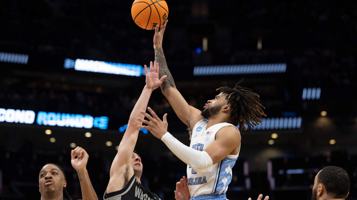 North Carolina’s R.J. Davis (4) puts up a shot against Wagner’s Javier Ezquerra (1) in the second half on Thursday, March 21, 2024 during the NCAA Tournament at Spectrum Center in Charlotte, N.C. Davis led all scores with 22 points in the Tar Heels’ 90-62 victory.