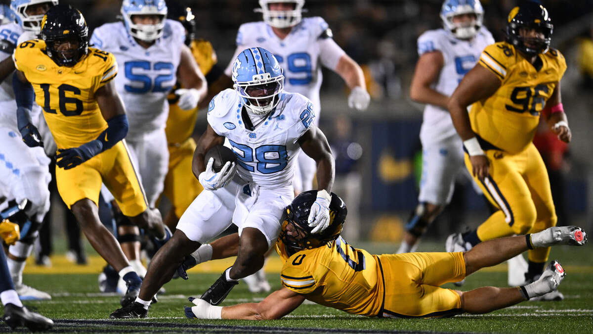 UNC’s Benjamin Hall (28) runs the ball against Cade Uluave (0) of the California Golden Bears during the first half at California Memorial Stadium on October 17, 2025 in Berkeley, California.