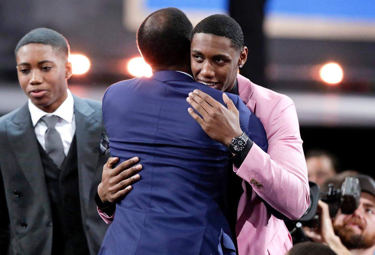 Duke’s RJ Barrett gets a hug after being selected as the third pick overall by the New York Knicks during the NBA basketball draft Thursday, June 20, 2019, in New York.