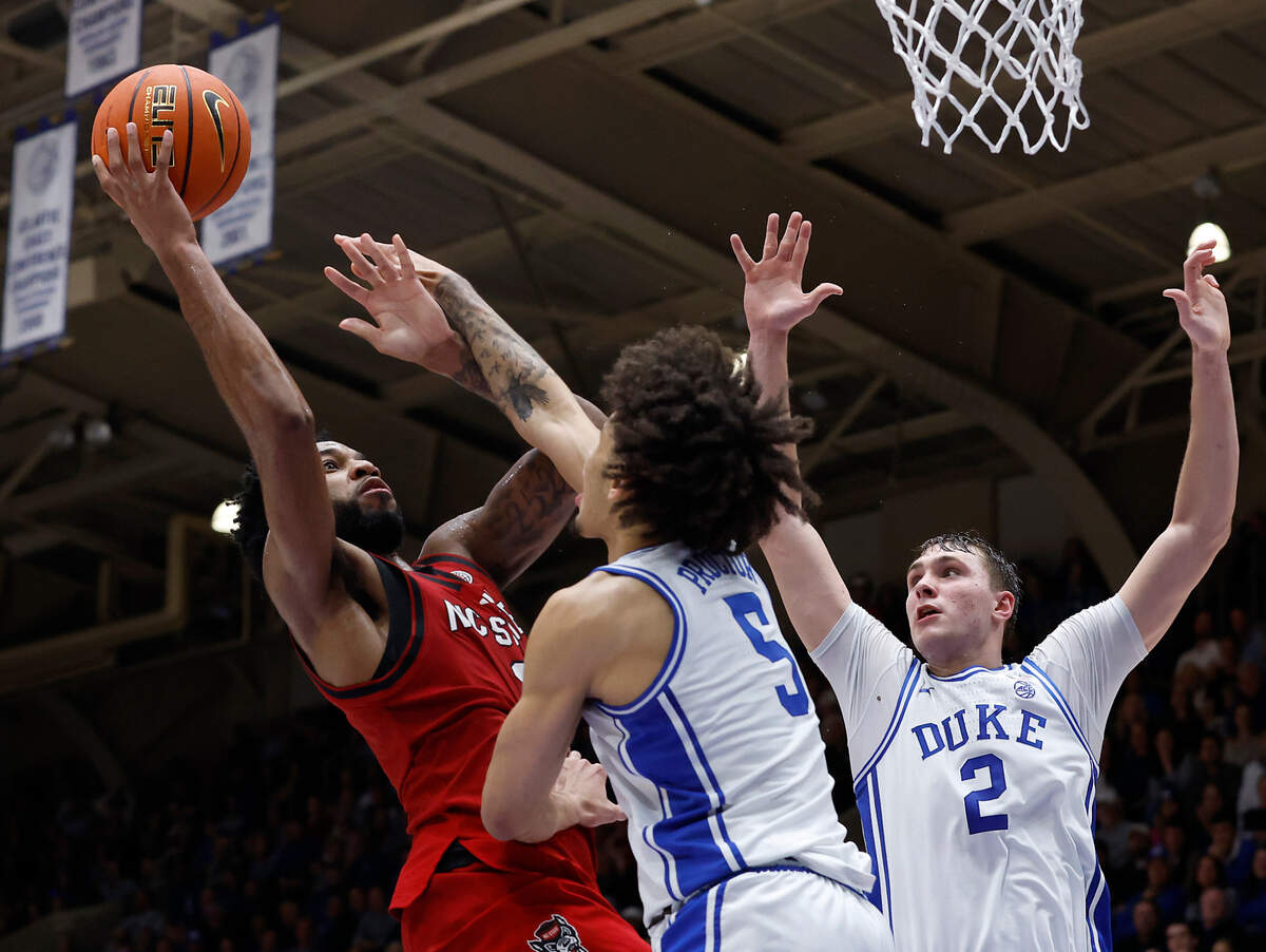 N.C. State’s Dontrez Styles shoots over Duke’s Tyrese Proctor and Cooper Flagg during the second half of the Wolfpack’s 74-64 loss on Monday, Jan. 27, 2025, at Cameron Indoor Stadium in Durham, N.C.