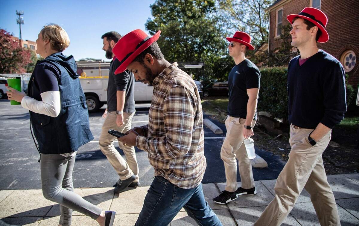 Red Hat employees walk back to their Raleigh headquarters after a meeting at the Duke Energy Center for the Performing Arts on Oct. 29, 2018.