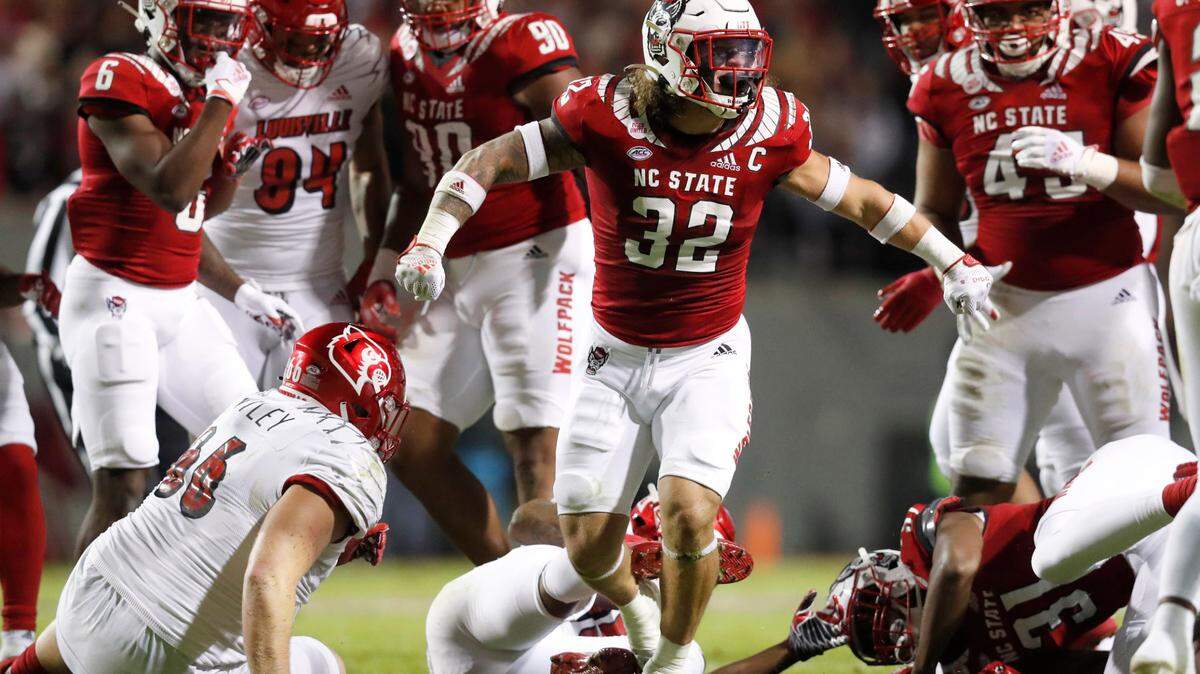 N.C. State linebacker Drake Thomas (32) celebrates after stopping Louisville running back Jalen Mitchell during the Wolfpack’s victory at Carter-Finley Stadium in October 2021.