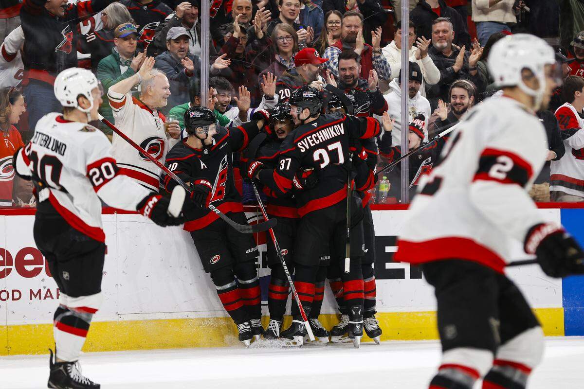 Seth Jarvis of the Carolina Hurricanes is mobbed by teammates after scoring a goal during the second period against the Ottawa Senators at Lenovo Center on Feb. 3, 2026 in Raleigh, North Carolina.