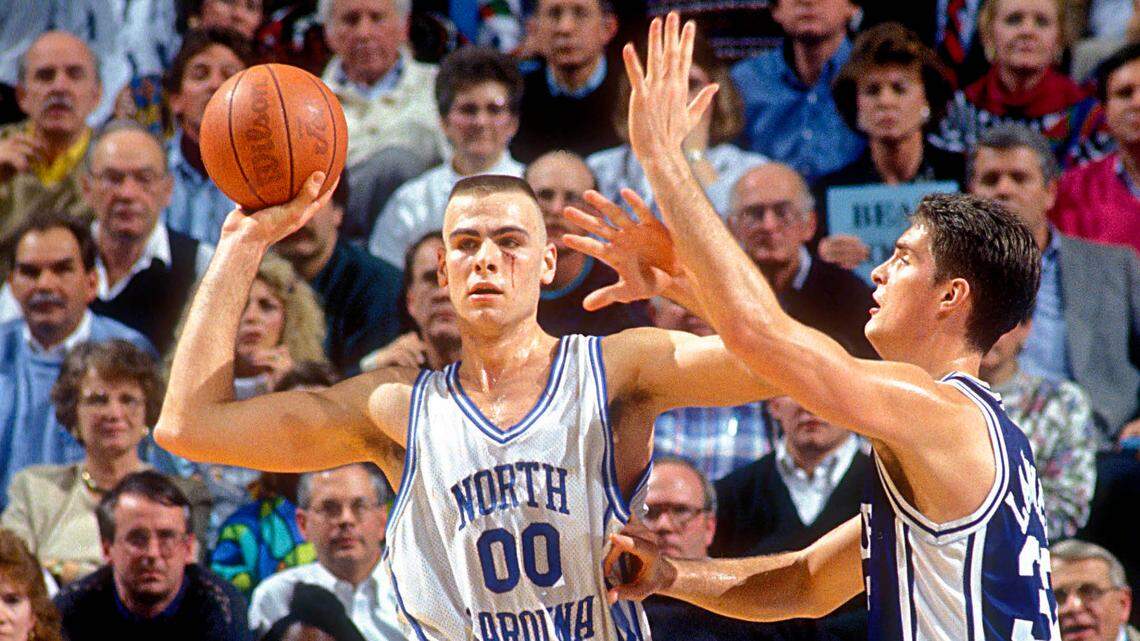 North Carolina Tar Heels center Eric Montross (00) looks to pass as Duke Blue Devils center Christian Laettner (32) defends in the Tar Heels 75-73 victory against the Blue Devils at the Dean E. Smith Center. Montross is playing with a cut below his left eye.