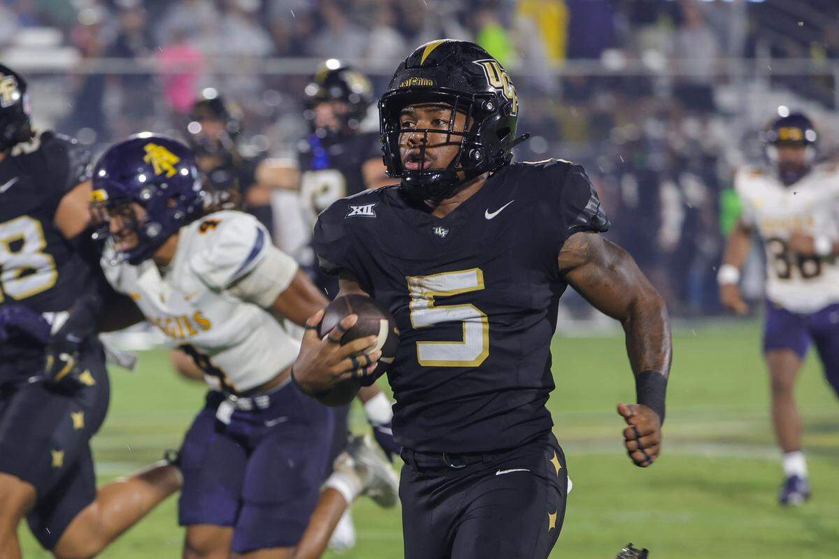 Sep 6, 2025; Orlando, Florida, USA; UCF Knights running back Jaden Nixon (5) runs a 96 yard kickoff return for a touchdown during the first quarter against the North Carolina A&T Aggies at Acrisure Bounce House. Mandatory Credit: Mike Watters-Imagn Images