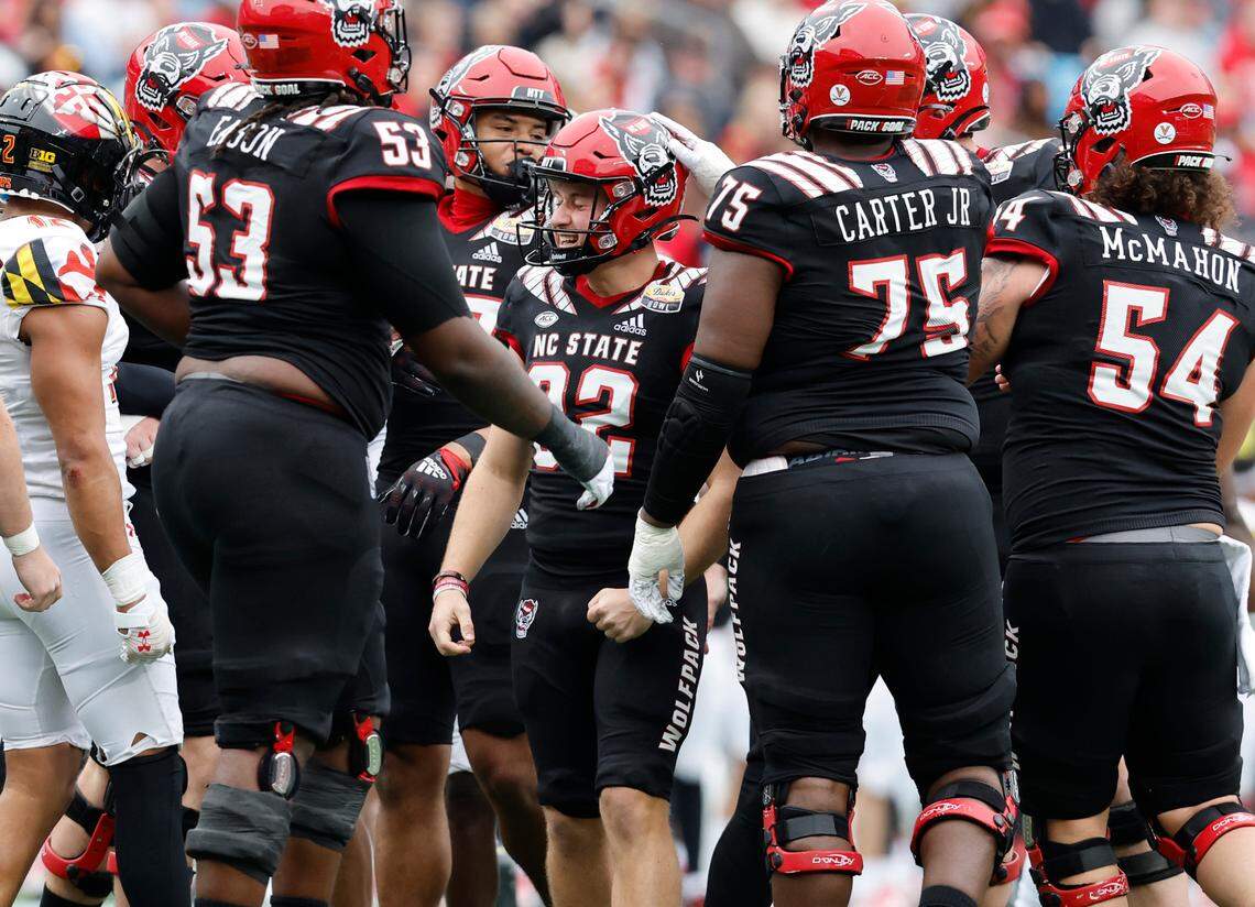 Players celebrates with Christopher Dunn (32) after he made a 38-yard field goal during the first half of N.C. State’s game against Maryland in the Duke’s Mayo Bowl at Bank of America Stadium in Charlotte, N.C., Friday, Dec. 30, 2022.