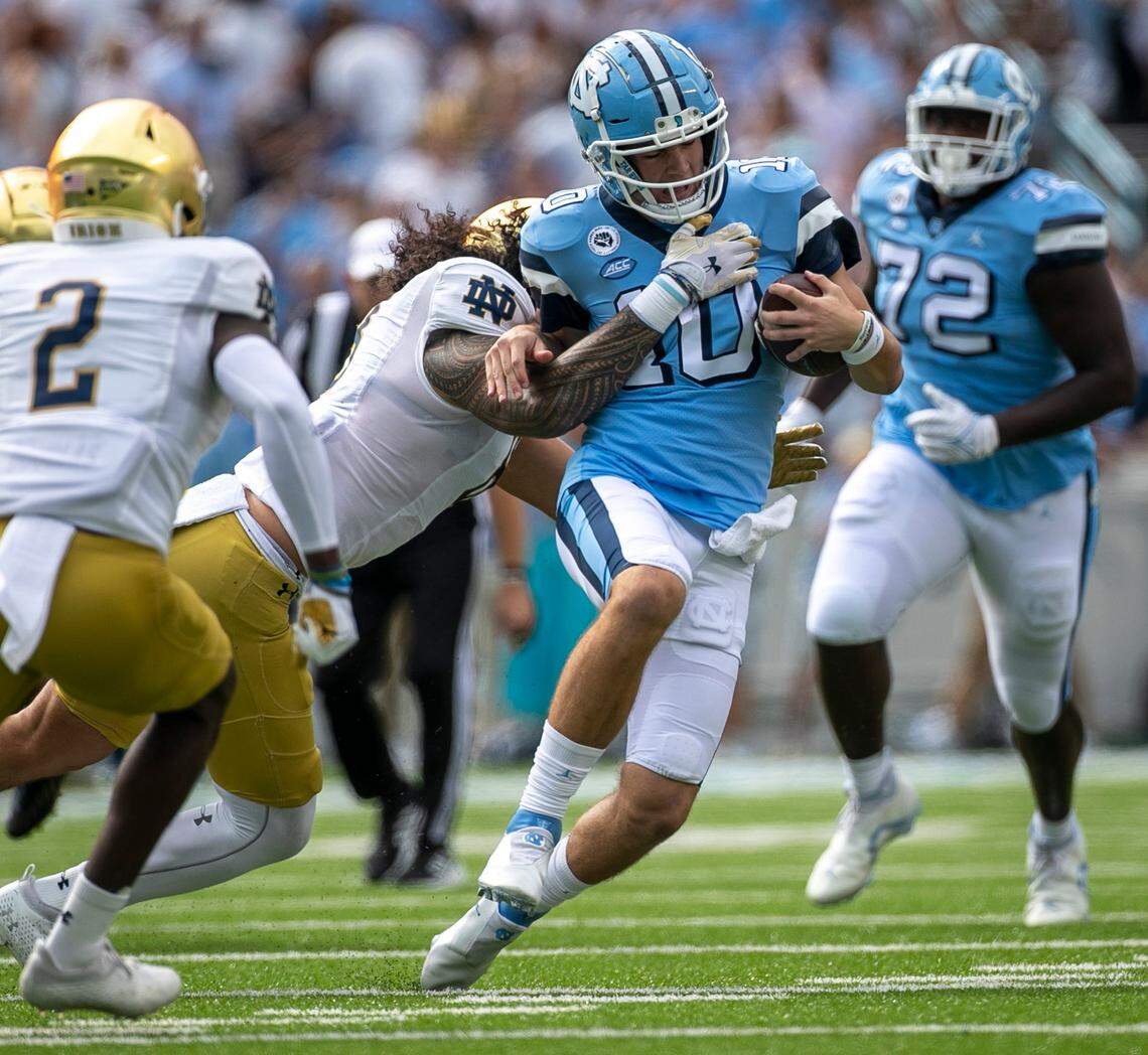 Notre Dame’s Marist Liufau (8) stops North Carolina quarterback Drake Maye (10) after a 15-yard again in the first quarter on Saturday, September 24, 2022 at Kenan Stadium in Chapel Hill, N.C.