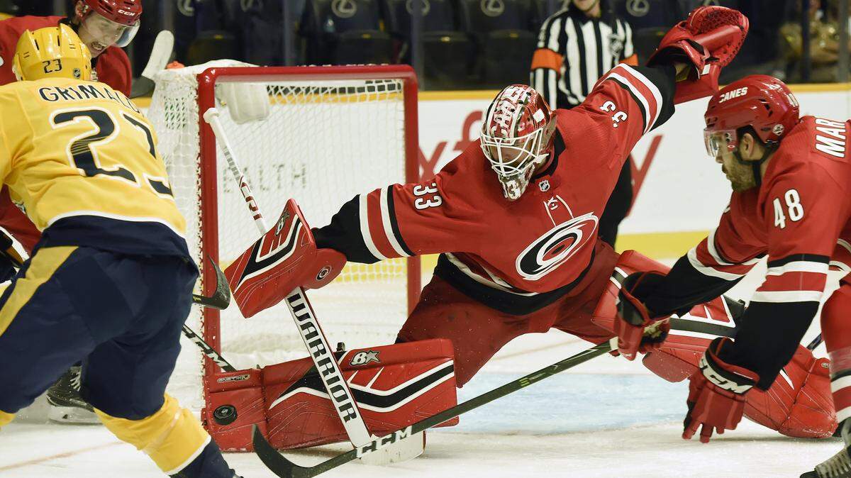 Carolina Hurricanes goaltender Scott Darling (33) blocks a shot by Nashville Predators center Rocco Grimaldi (23) during the second period of an NHL preseason hockey game Tuesday, Sept. 25, 2018, in Nashville, Tenn. 