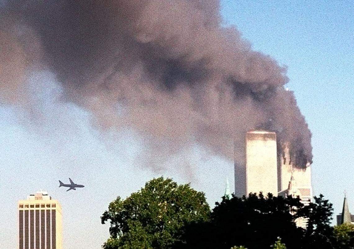 A plane approaches New York's World Trade Center moments before it struck the tower at left, as seen from downtown Brooklyn, Tuesday, Sept. 11, 2001.