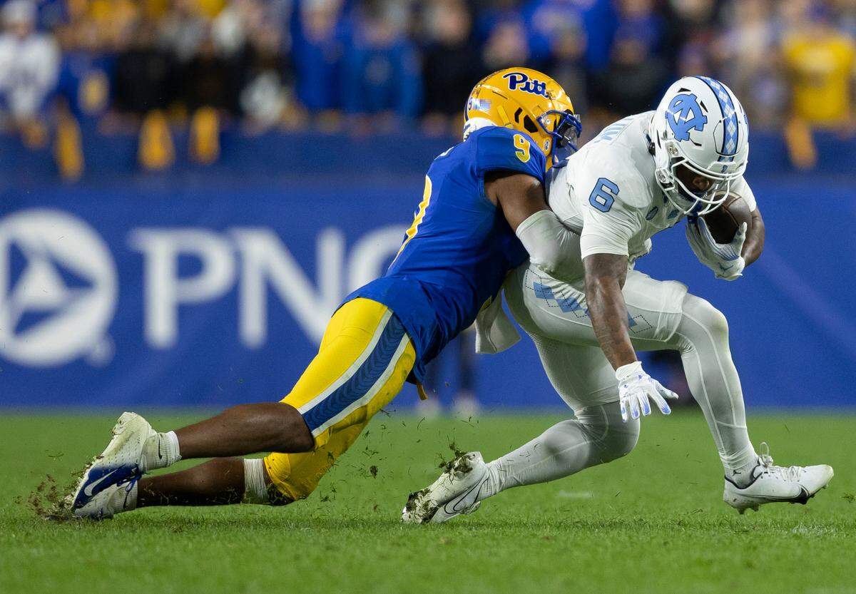 North Carolina’s Nate McCollum (6) is stopped by Pitt’s A.J. Woods (9) after a five-yard pass completion from quarterback Drake Maye in the third quarter on Saturday, September 23, 2023 at Acrisure Stadium in Pittsburgh, Pa.