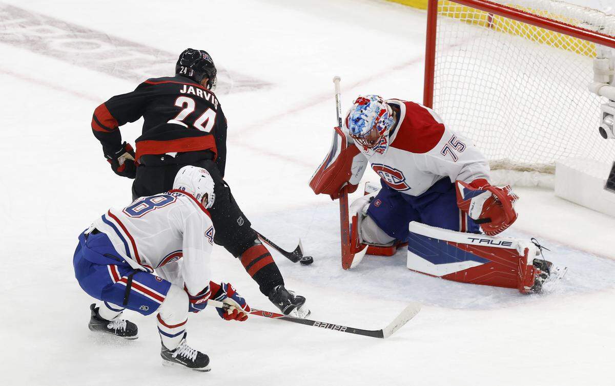 Montréal's Jakub Dobes (75) stops a shot by Carolina's Seth Jarvis (24) during the second period of the Hurricanes’ game against the Canadiens in game one of the Eastern Conference Finals at the Lenovo Center Thursday, May, 21, 2026.