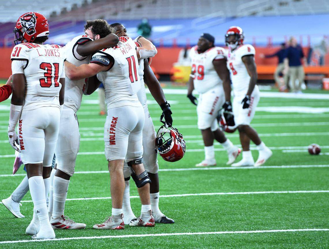 North Carolina State players, including Payton Wilson (11), celebrate after their win over Syracuse on Saturday, Nov. 28, 2020, at the Carrier Dome in Syracuse, N.Y.