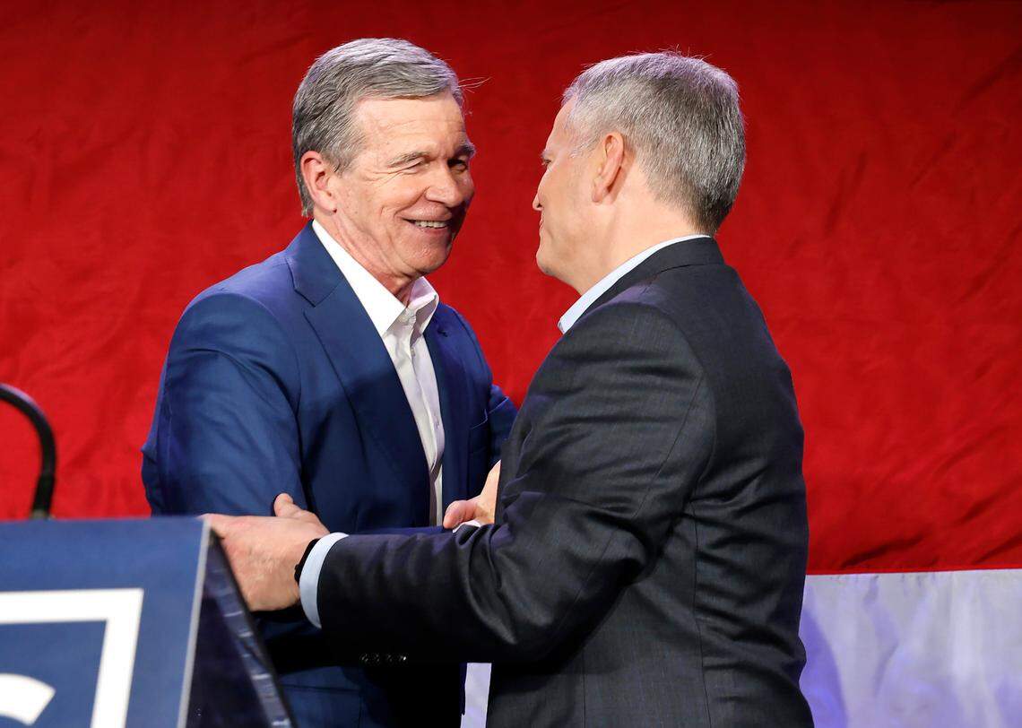 Gov. Roy Cooper greets governor-elect Josh Stein during a North Carolina Democratic Party election night event at the Marriott City Center in Raleigh, N.C., Tuesday, Nov. 5, 2024.