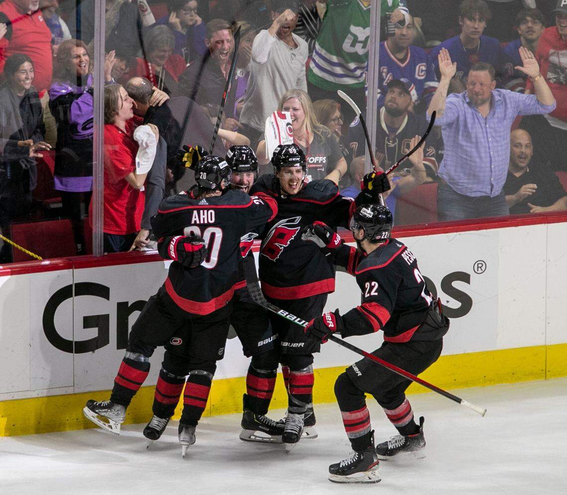 Carolina Hurricanes Brendan Smith (7) and Sebastian Aho (20), Martin Necas (88) and Brett Pesce (22) react after Smiths goal on New York Rangers goalie Igor Shesterkin (31) to give the Hurricanes a 1-0 lead in the second period on Friday, May 20, 2022 during game two of the Stanley Cup second round at PNC Arena in Raleigh, N.C
