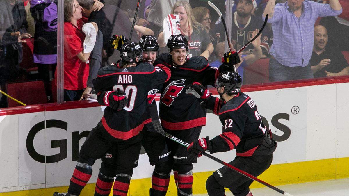 Carolina Hurricanes Brendan Smith (7) and Sebastian Aho (20), Martin Necas (88) and Brett Pesce (22) react after Smiths goal on New York Rangers goalie Igor Shesterkin (31) to give the Hurricanes a 1-0 lead in the second period on Friday, May 20, 2022 during game two of the Stanley Cup second round at PNC Arena in Raleigh, N.C