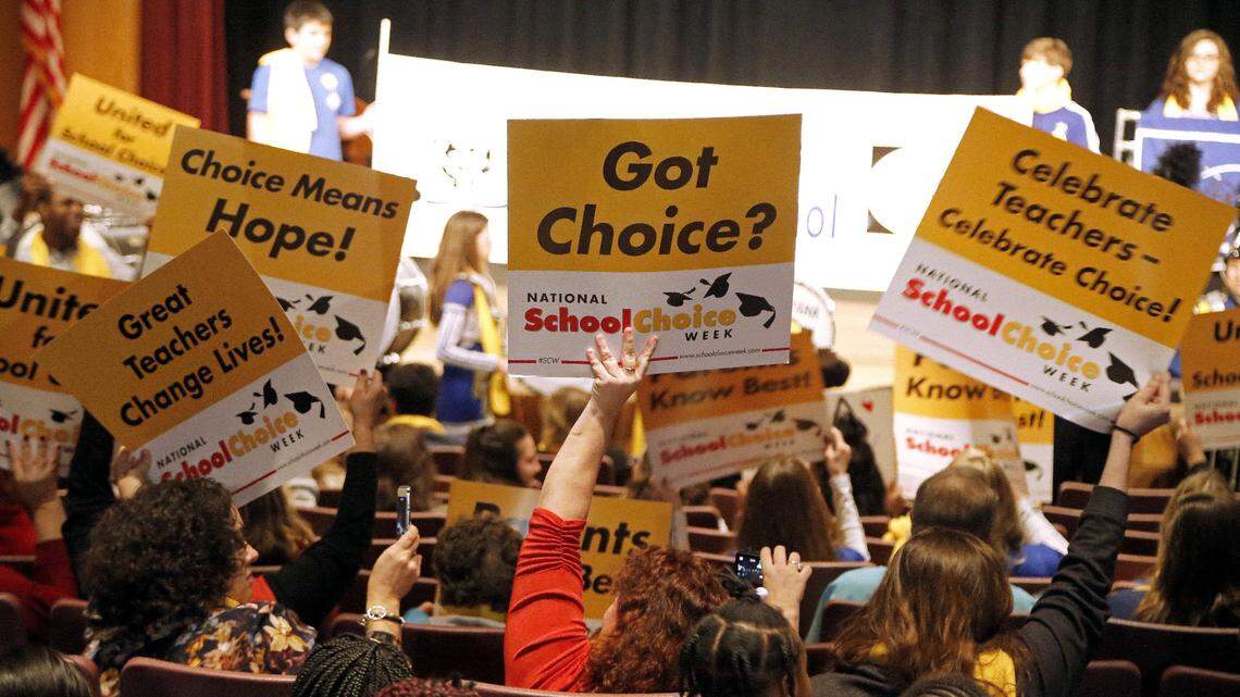 Attendees wave signs showing their support for school choice as hundreds came to a school choice rally held at the N.C. Museum of History on Jan. 23, 2018.