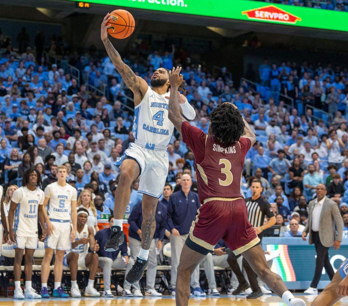 North Carolina guard R.J. Davis (4) drives to the basket against Elon’s T.K. Simpkin’s (3) during the second half on Monday, November 4, 2024 at the Smith Center in Chapel Hill, N.C. Davis lead all scores with 24 points in the Tar Heels’ 90-76 victory.