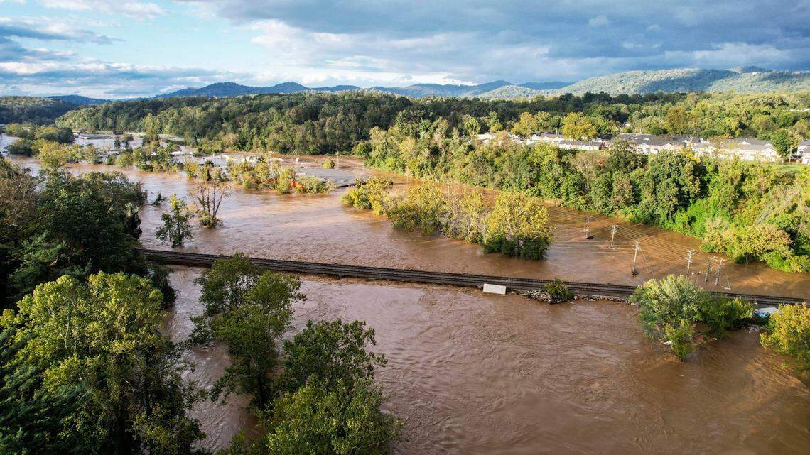 The French Broad River breaks its banks in Asheville on Friday, Sept. 27, 2024 as the remnants of Hurricane Helene caused flooding, downed trees, and power outages in western North Carolina.