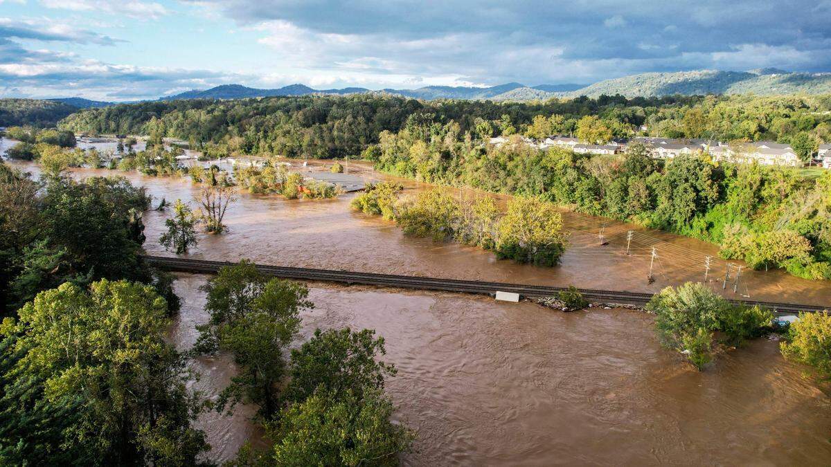 The French Broad River breaks its banks in Asheville on Friday, Sept. 27, 2024 as the remnants of Hurricane Helene caused flooding, downed trees, and power outages in western North Carolina.