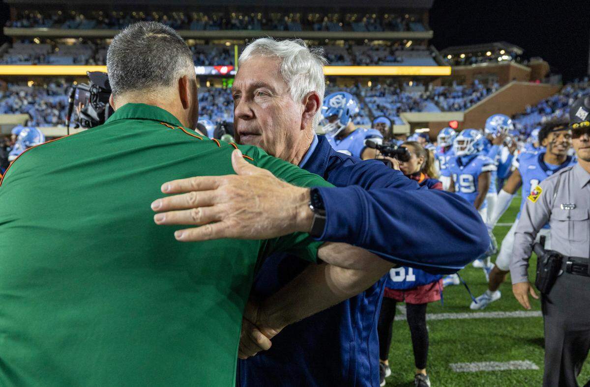 Miami coach Mario Cristobal congratulates North Carolina coach Mack Brown following the Tar Heels’ 41-31 victory over Miami on Saturday, October 14, 2023 at Kenan Stadium in Chapel Hill, N.C.