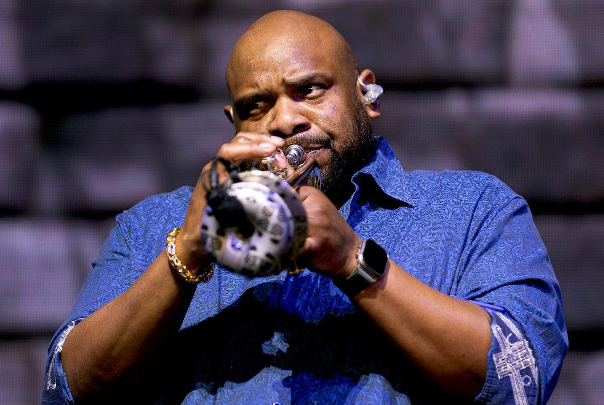 The Dave Matthews Band trumpet player Rashawn Ross eases the crowd into their show at Raleigh, N.C.’s Coastal Credit Union at Walnut Creek, Friday night, June 14, 2024.