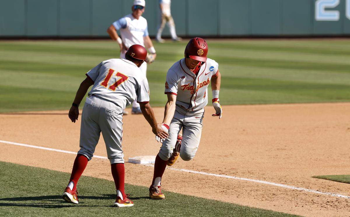 Southern California's Dean Carpentier (6) is congratulated by Travis Jewett after hitting a grand slam home run during UNC’s game against USC in the first game of the Chapel Hill Super Regional at Boshamer Stadium in Chapel Hill, N.C., Friday, June 5, 2026.
