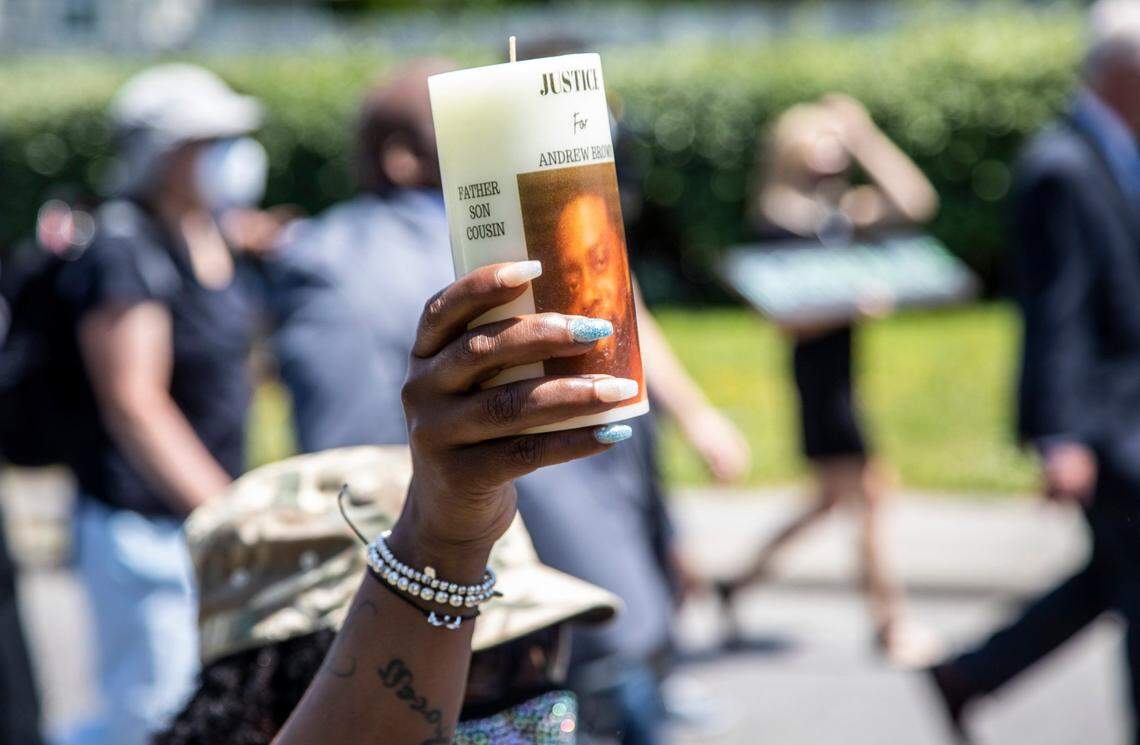 A demonstrators holds a candle as protesters led by clergy march Wednesday, April 28, 2021 from Mt. Lebanon AME Zion Church in Elizabeth City to the site where Andrew Brown Jr. was shot and killed by Pasquotank County Sheriff deputies. A Pasquotank County judge denied the petition by the media to release the body camera footage in the shooting of Andrew Brown Jr.