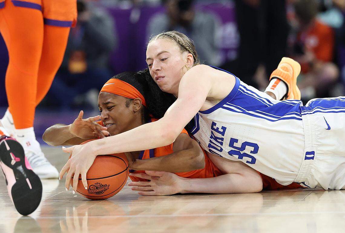 Mia Moore (12) of the Clemson Tigers dives for a loose ball against Toby Fournier of the Duke Blue Devils during the first quarter of their Women’s ACC Tournament quarterfinal at Gas South Arena on March 6, 2026 in Duluth, Georgia.