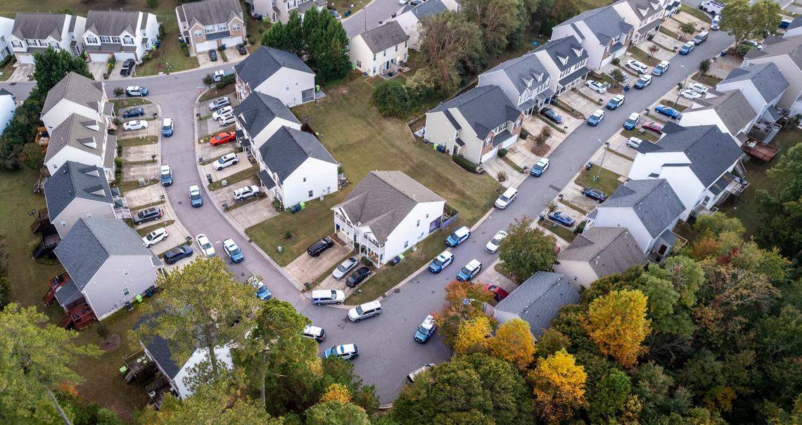 Police line the streets while officers respond to the lethal shooting rampage in Hedingham near the Neuse River Trail on Oct. 13, 2022.
