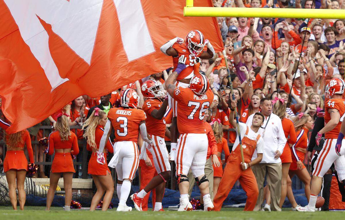 Clemson running back Travis Etienne (9) celebrates with Sean Pollard (76) after scoring on a 3-yard run during the first half of N.C. State’s game against Clemson at Memorial Stadium in Clemson, S.C., Saturday, Oct. 20, 2018.