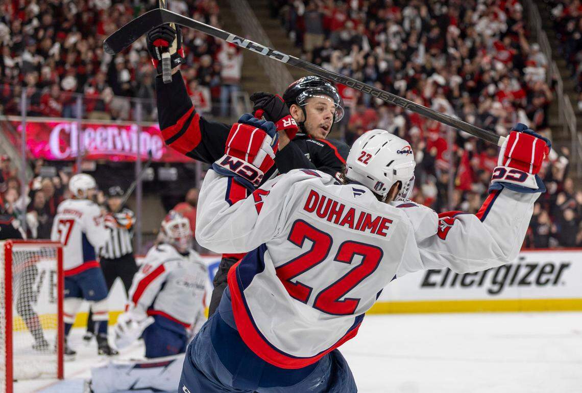 Carolina Hurricanes center Jesperi Kotkaniemi (82) checks Washington Capitals right wing Brandon Duhaime (22) in the first period during Game 4 of their series on Monday, May 12, 2025 at Lenovo Center in Raleigh, N.C.