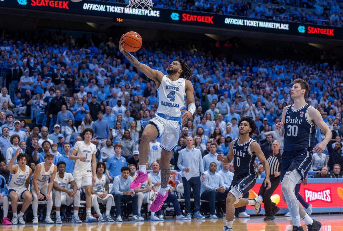 North Carolina’s R.J. Davis (4) breaks to the basket past Duke’s Jared McCain (0) and Kyle Filipowski (30) in the second half on Saturday, February, 3, 2024 at the Dean E. Smith Center in Chapel Hill, N.C.