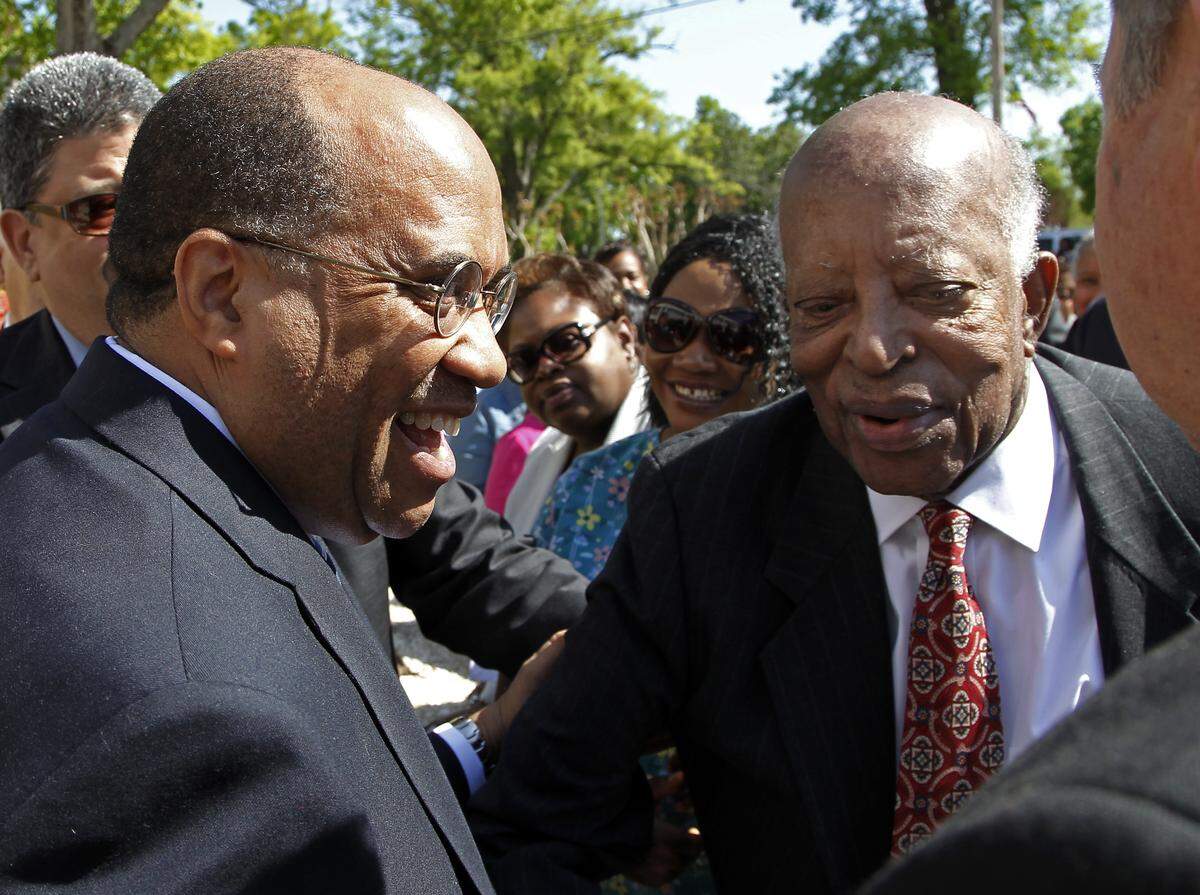 Dr. Everett Ward, left, is congratulated by former school President Prezell Robinson after he was named the Interim President of St. Augustine’s University in Raleigh, NC during a ceremony held at the on campus on April 23, 2014.