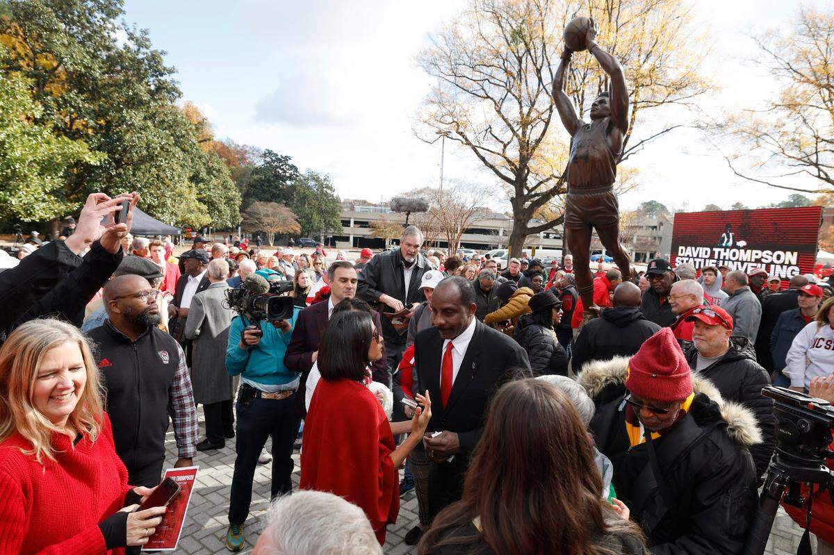 Crowds surround N.C. State’s David Thompson after his statue was unveiled outside Reynolds Coliseum in Raleigh, N.C., Wednesday, Dec. 6, 2023.