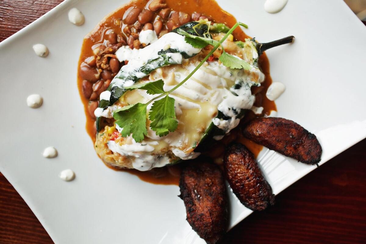 The chile relleno from Frida’s Patio in Cary is a large roasted poblano, split open and filled like a loaded potato with shrimp, vegetables, rice and melted cheese, served with scratch-made charro beans and sweet plantains.