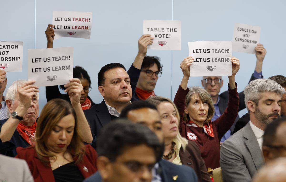 Members of the American Association of University Professors silently protest as the UNC Board of Governors authorize a new definition of academic freedom during their meeting in Raleigh, N.C., Thursday, Feb. 26, 2026.