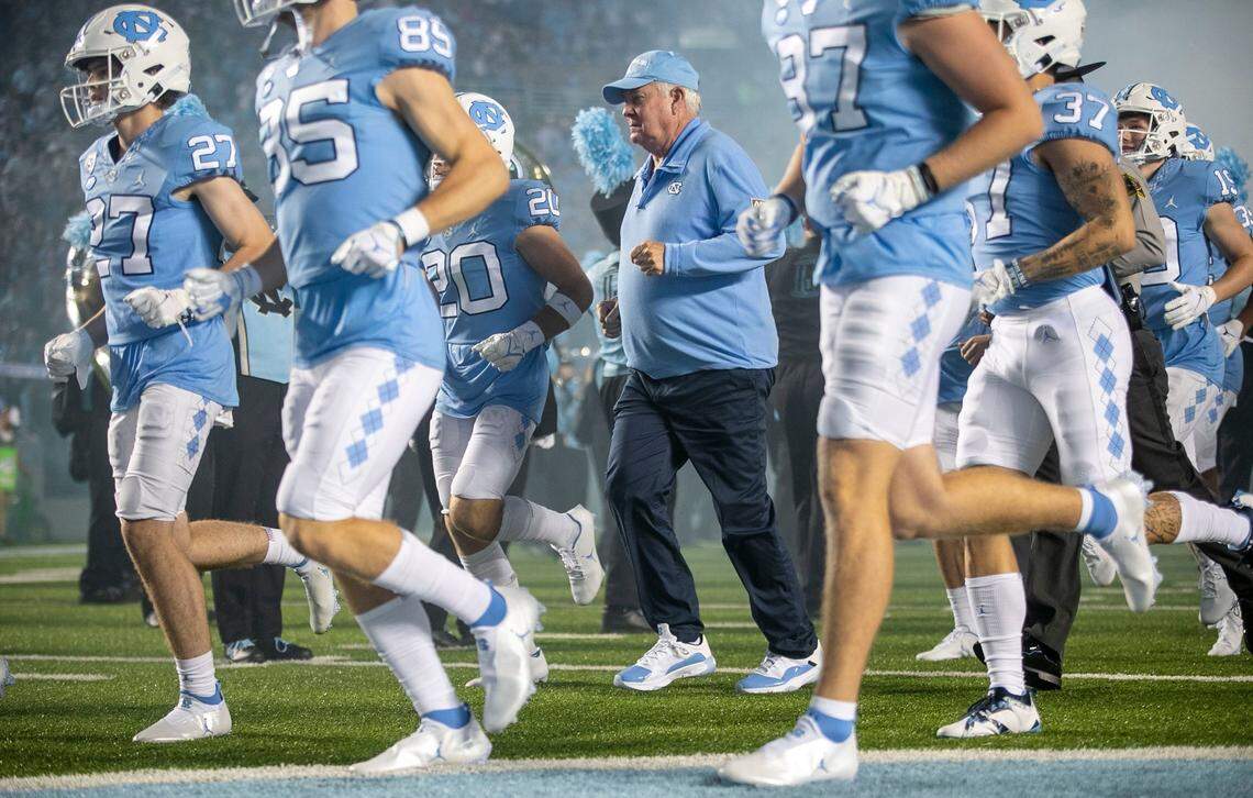 North Carolina coach Mack Brown enters the field with his players for their game against Florida A&M on Saturday, August 27, 2022 at Kenan Stadium in Chapel Hill, N.C.